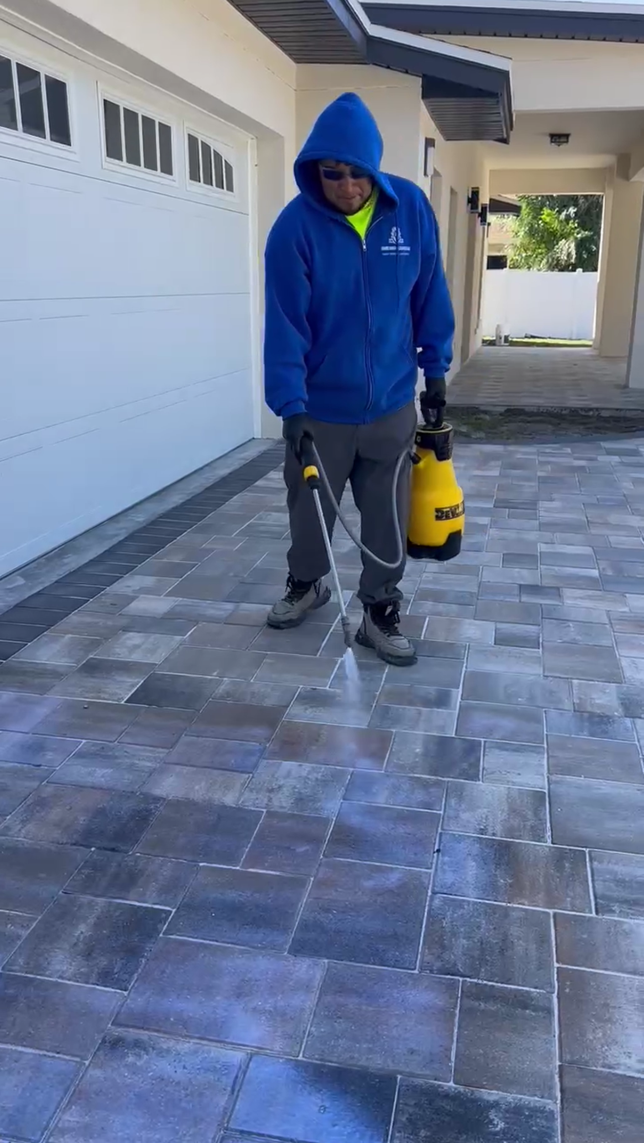 Hard working man is sealing the pavers